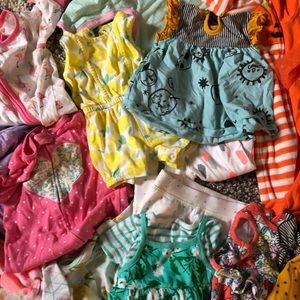 A bunch of baby girl clothes